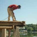 Construction worker standing on a deck during construction