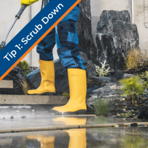 person in yellow boots with hose cleaning patio to get ready for summer