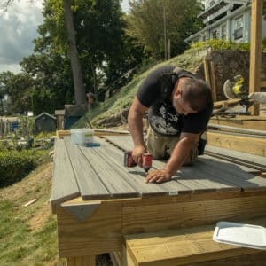 contractor measuring lines on a deck installation