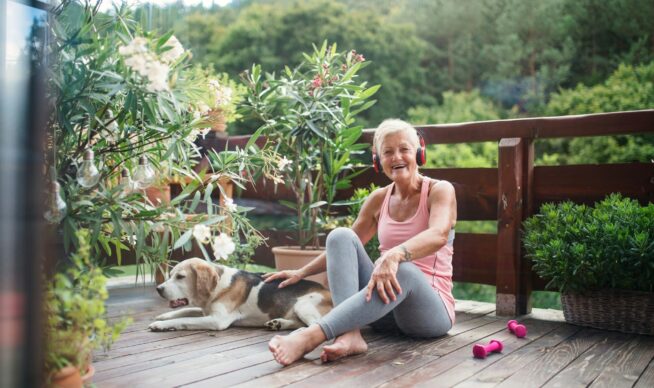 woman sitting on floor of deck