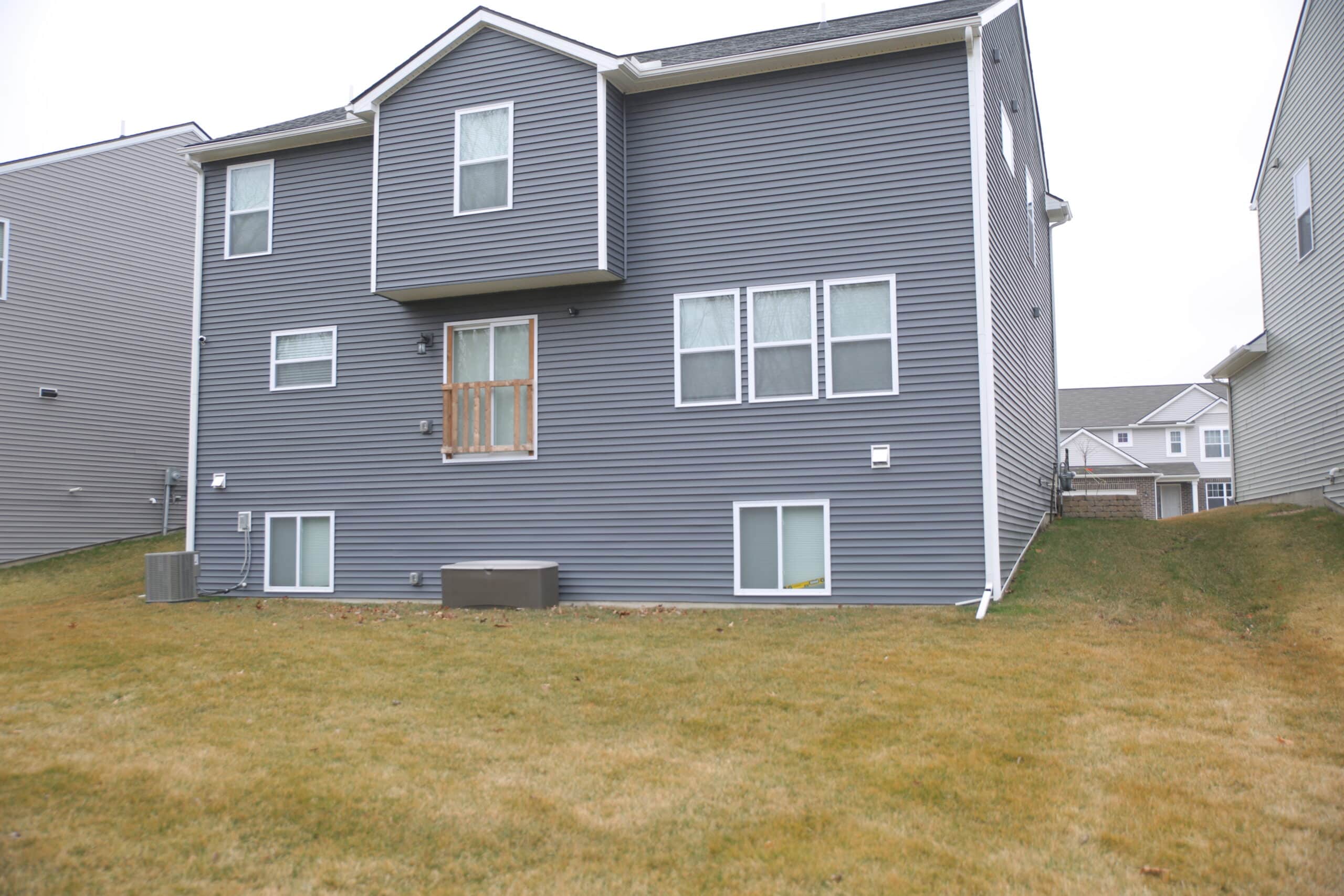 View of the backyard of a home without a deck. 