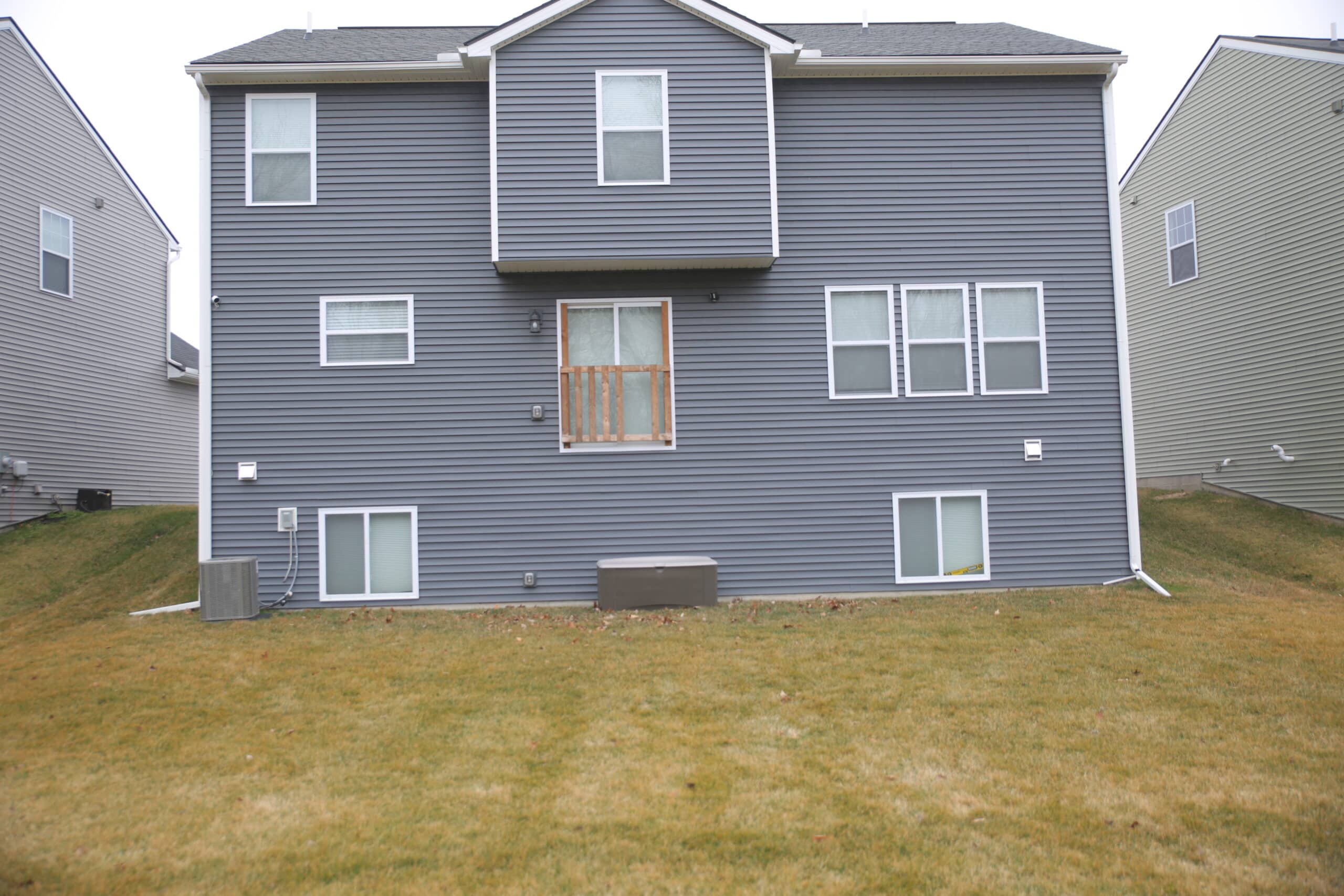 View of the backyard of a home without a deck. 