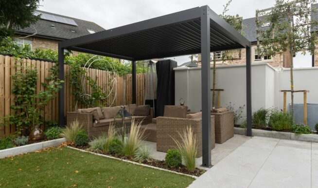 dark gray pergola in an outdoor living space.