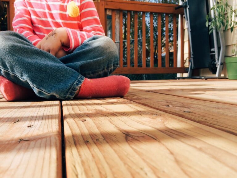 Child sitting on an outdoor deck