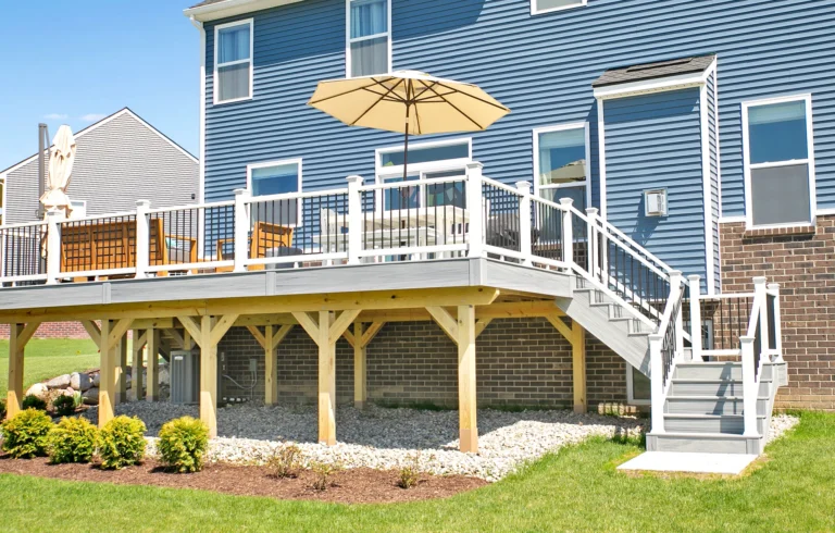 Deck on sunny day with yellow umbrella and outdoor furniture