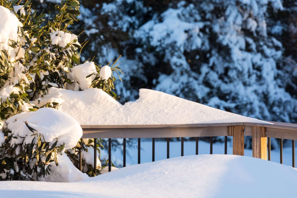 Snow covered deck and railing