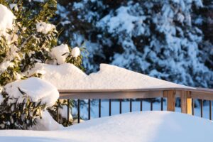 Snow covered deck and railing