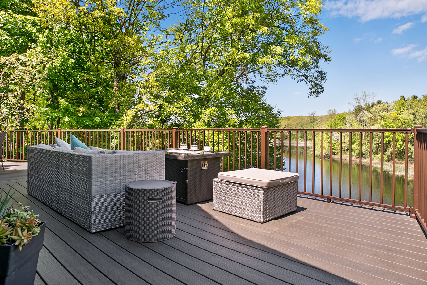 a new deck with furniture over looking water.