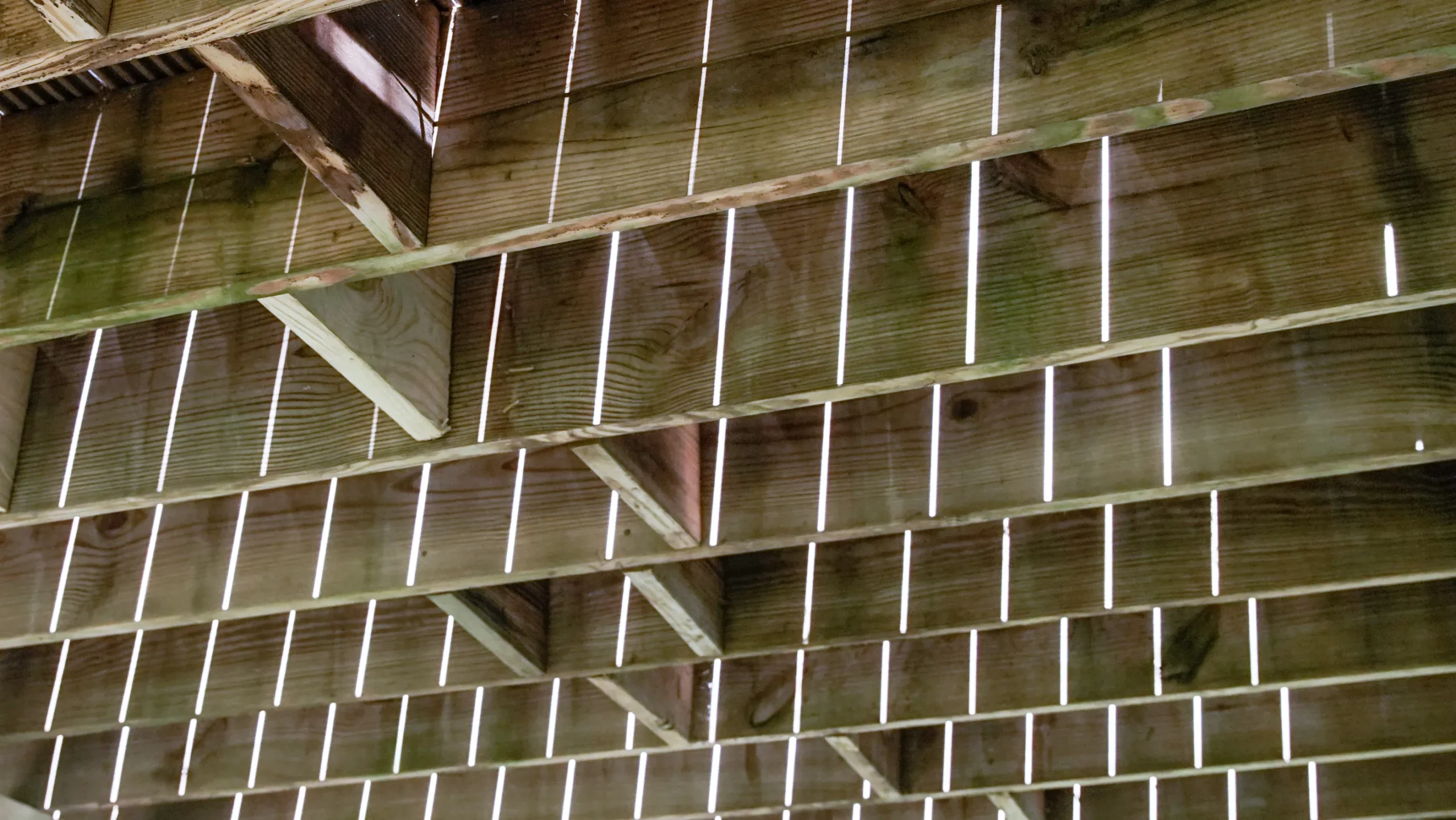 Close up of the wooden supports under a deck.