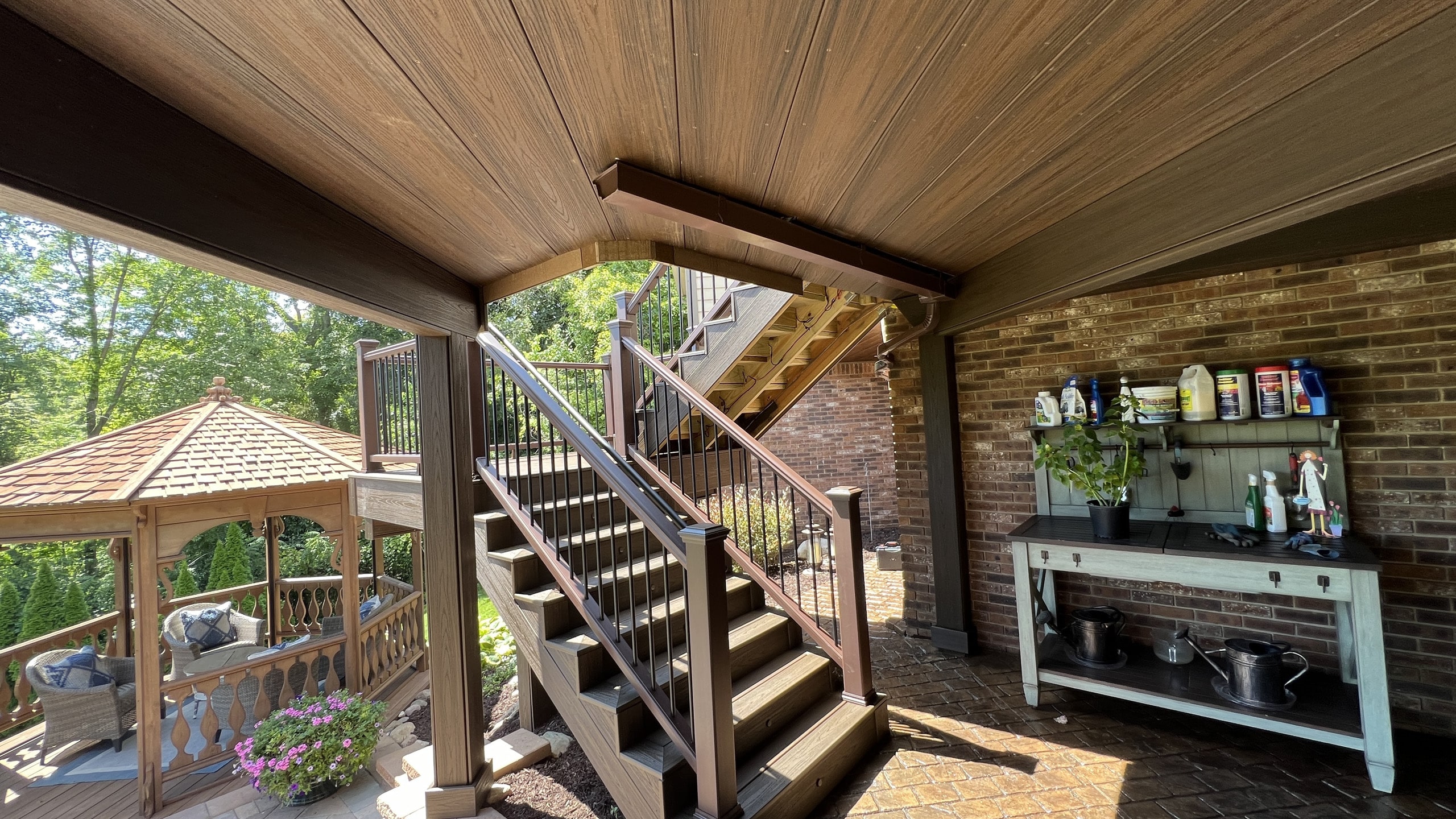 Close up of custom stairs with metal railing leading to dryspace under composite deck