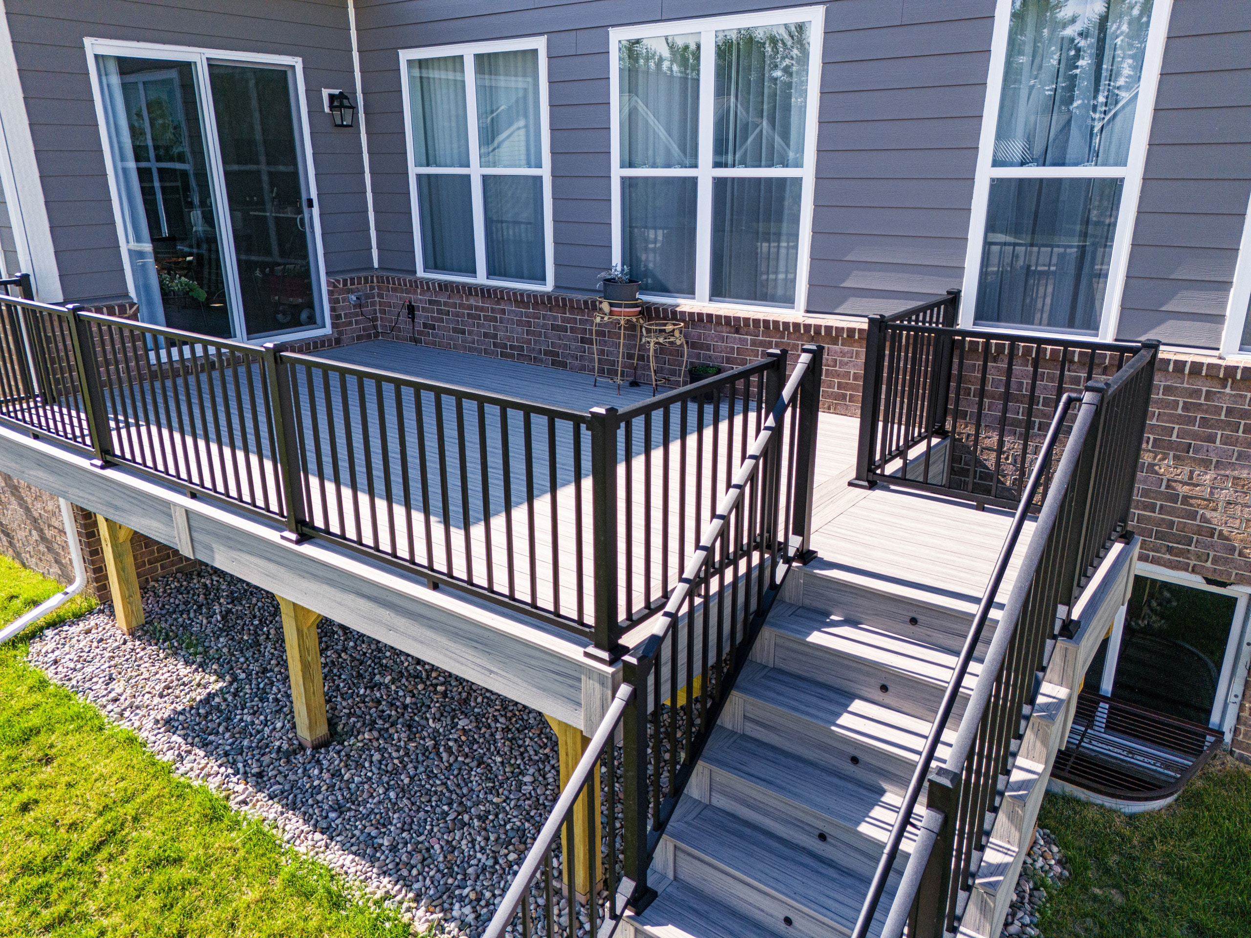 Closeup of stairs with metal railing and composite decking material in Ann Arbor, MI