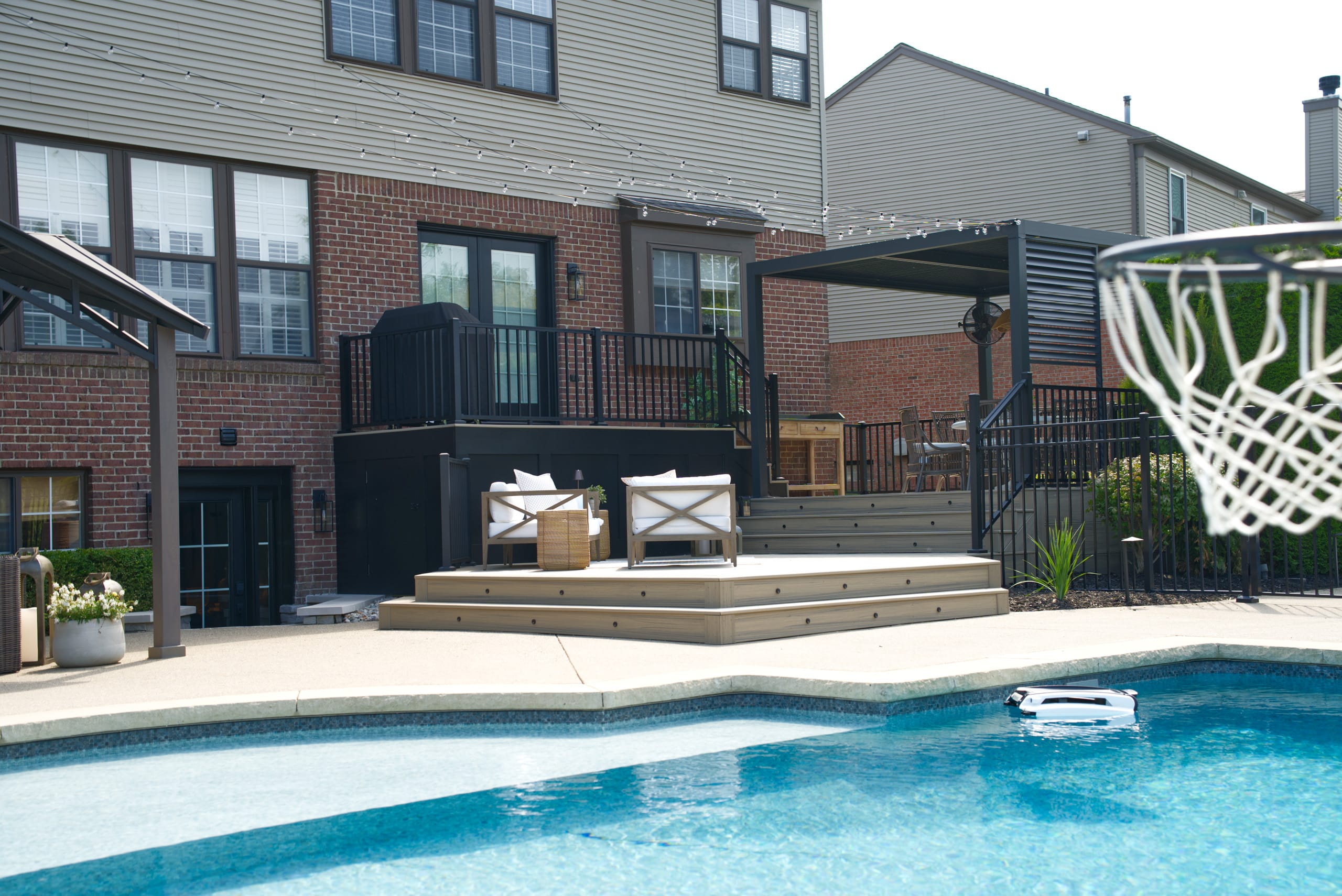 Shot of the patio door opening to a small deck leading down to a larger deck, then to steps to the pool area
